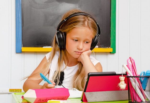 causacian-cute-school-kid-with-earphones-is-boring-online-home-education_106885-2193-min